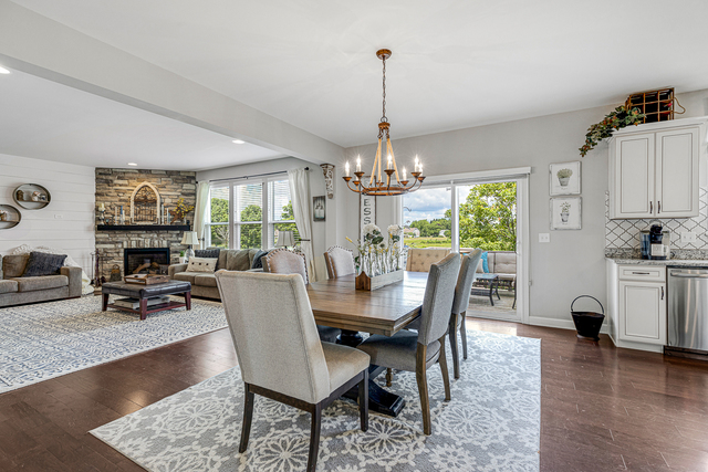 4380 John Milton Road Elgin, IL 60124 - Photo 8 of 30 a dining room with furniture a chandelier and wooden floor