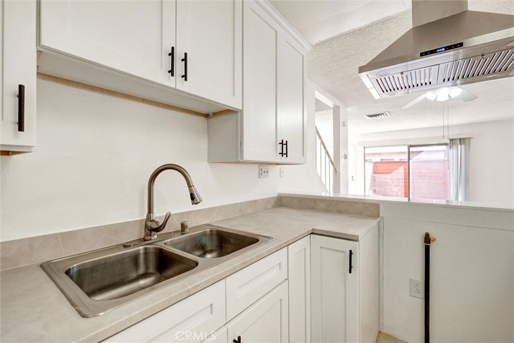 7033 Stewart And Gray Road, Unit 24 Downey, CA 90241 - Photo 11 of 39 a kitchen with a sink and cabinets