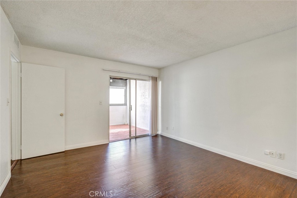 7033 Stewart And Gray Road, Unit 24 Downey, CA 90241 - Photo 20 of 39 a big room with wooden floor and windows