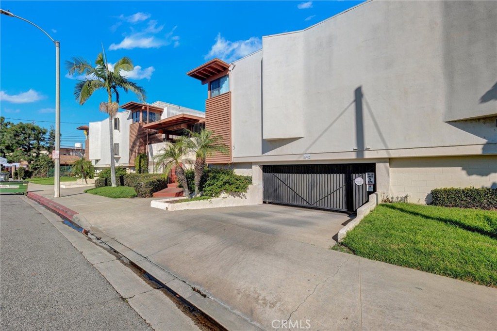 7033 Stewart And Gray Road, Unit 24 Downey, CA 90241 - Photo 3 of 39 a front view of a house with a yard and potted plants