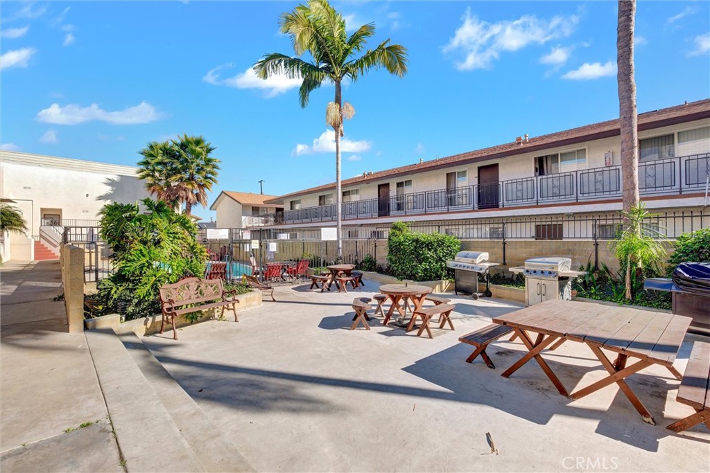7033 Stewart And Gray Road, Unit 24 Downey, CA 90241 - Photo 32 of 39 a view of a patio with couches table and chairs and potted plants