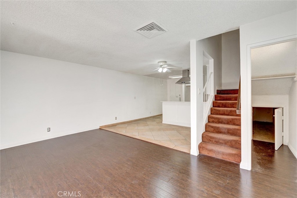 7033 Stewart And Gray Road, Unit 24 Downey, CA 90241 - Photo 5 of 39 wooden floor in an empty room with wooden floor and stairs