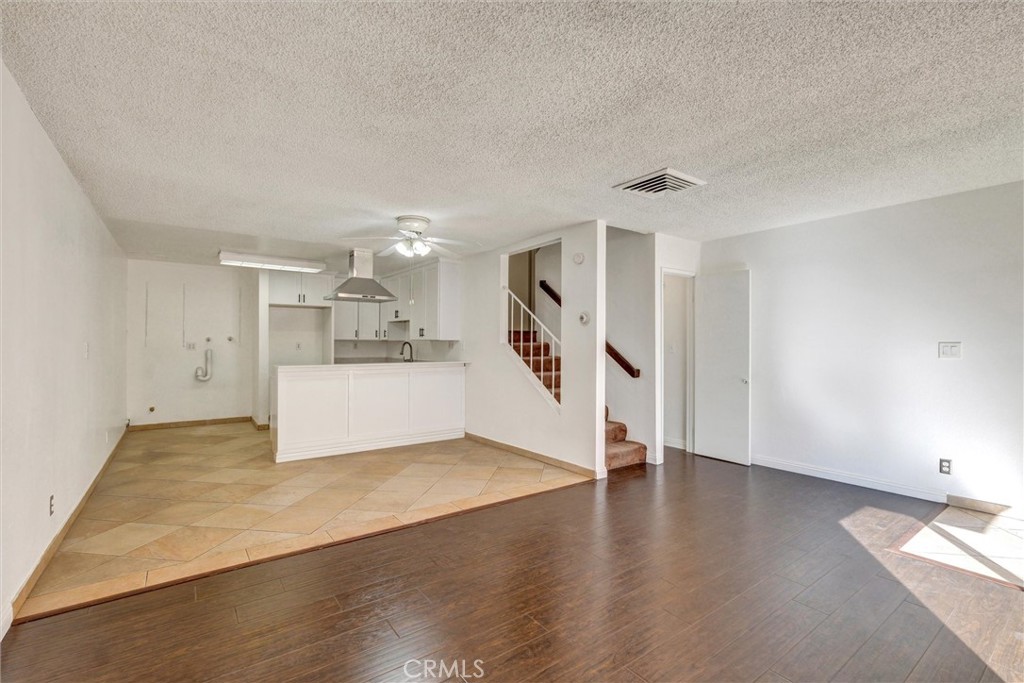 7033 Stewart And Gray Road, Unit 24 Downey, CA 90241 - Photo 6 of 39 a view of a kitchen with wooden floor and a refrigerator