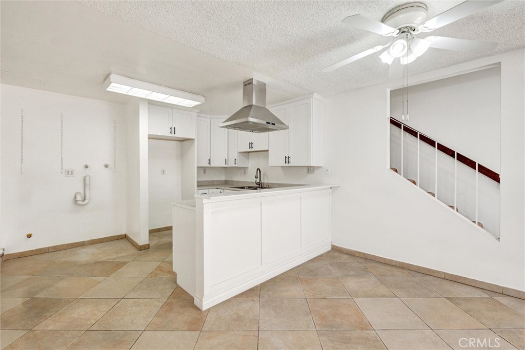 7033 Stewart And Gray Road, Unit 24 Downey, CA 90241 - Photo 8 of 39 a kitchen with a cabinets and chandelier