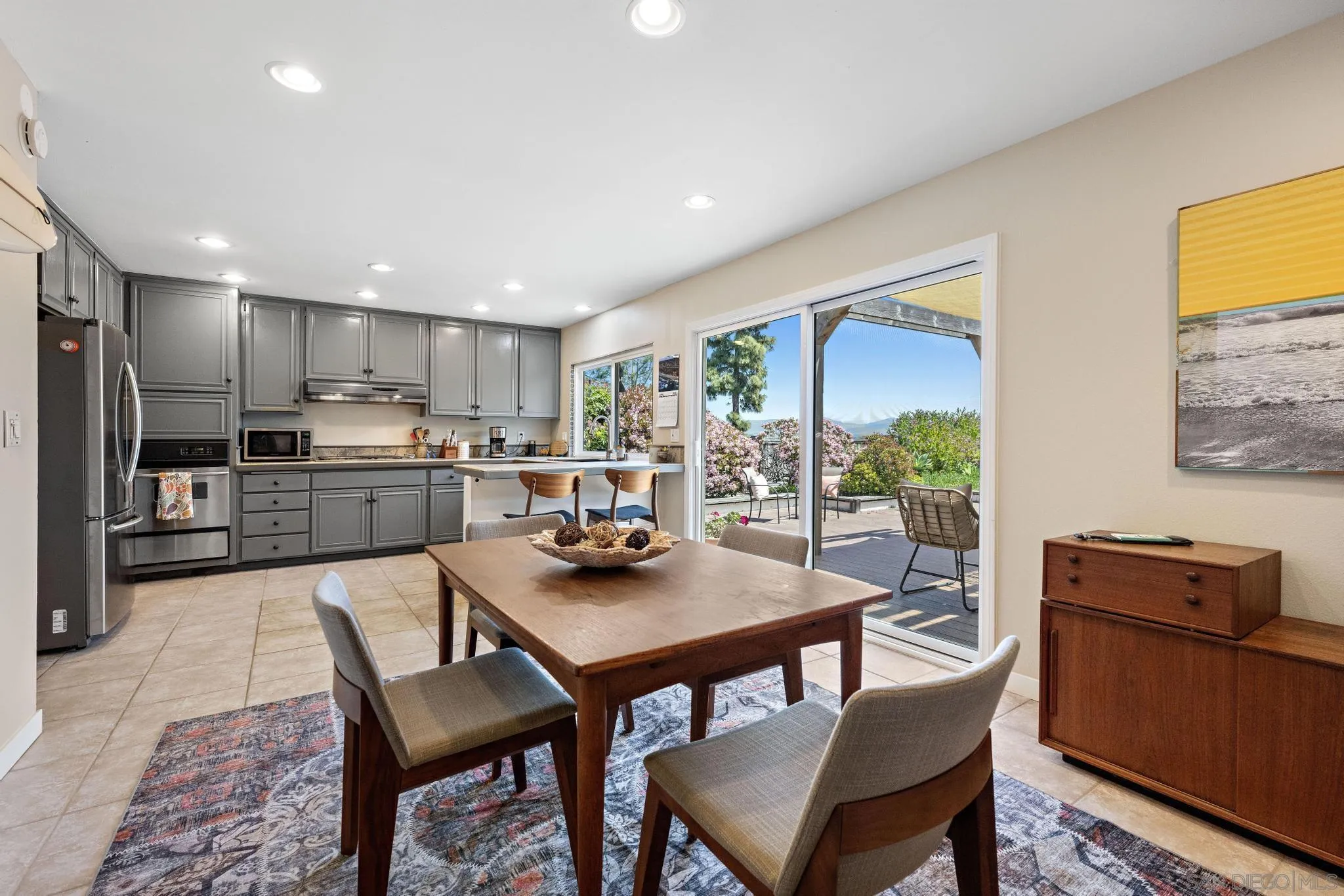 149 Beechtree Drive Encinitas, CA 92024 - Photo 12 of 55 a kitchen with a dining table chairs and refrigerator