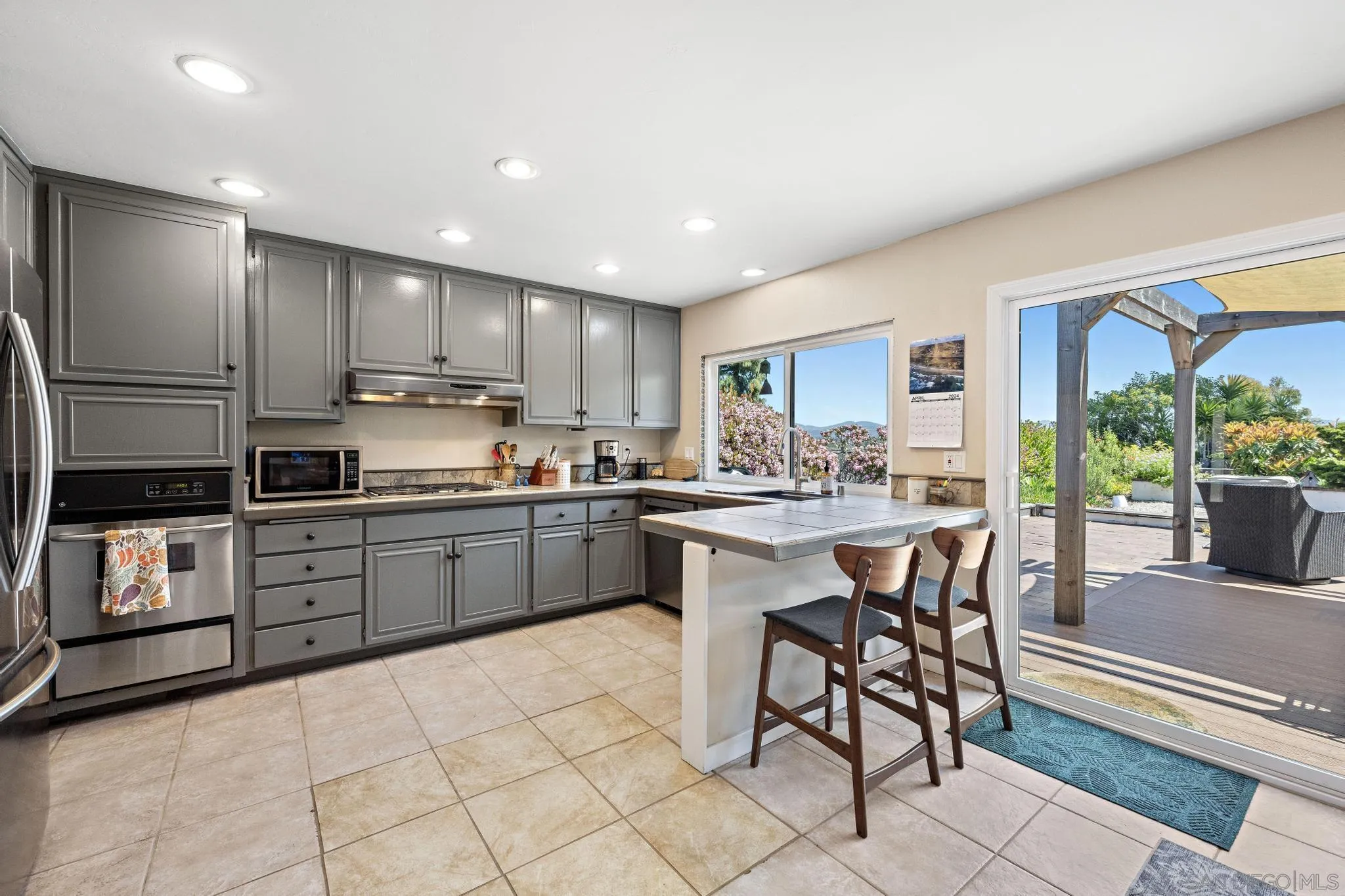 149 Beechtree Drive Encinitas, CA 92024 - Photo 13 of 55 a kitchen with stainless steel appliances granite countertop a stove a sink a refrigerator and a refrigerator