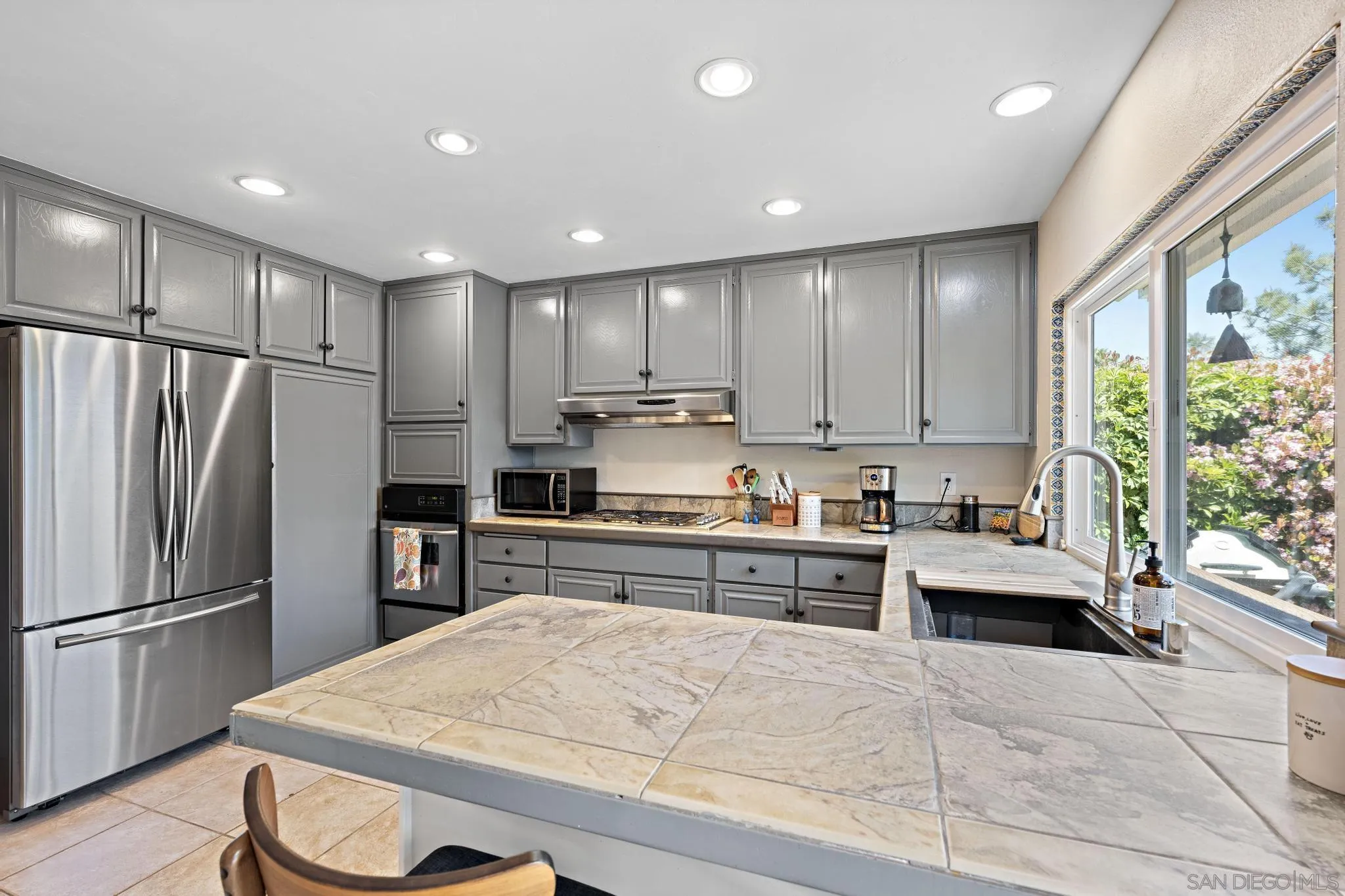 149 Beechtree Drive Encinitas, CA 92024 - Photo 14 of 55 a kitchen with granite countertop stainless steel appliances a refrigerator sink microwave and stove