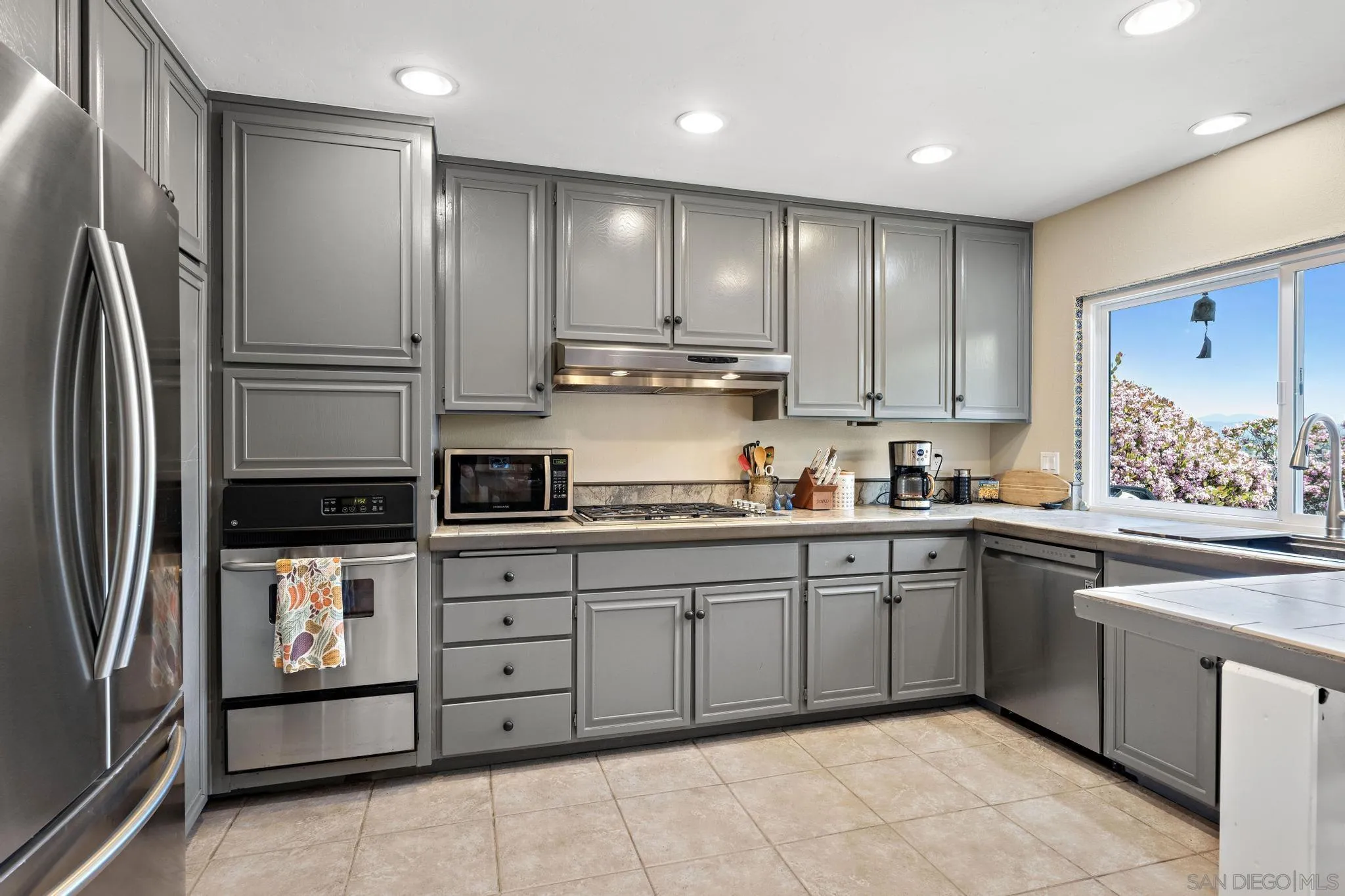 149 Beechtree Drive Encinitas, CA 92024 - Photo 15 of 55 a kitchen with stainless steel appliances granite countertop a refrigerator and a stove top oven