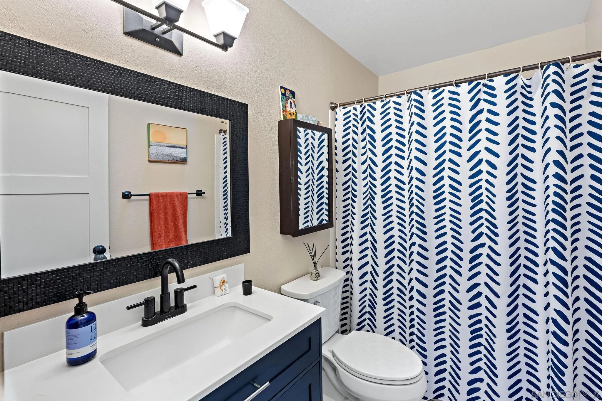 149 Beechtree Drive Encinitas, CA 92024 - Photo 18 of 55 a bathroom with a sink a toilet and mirror