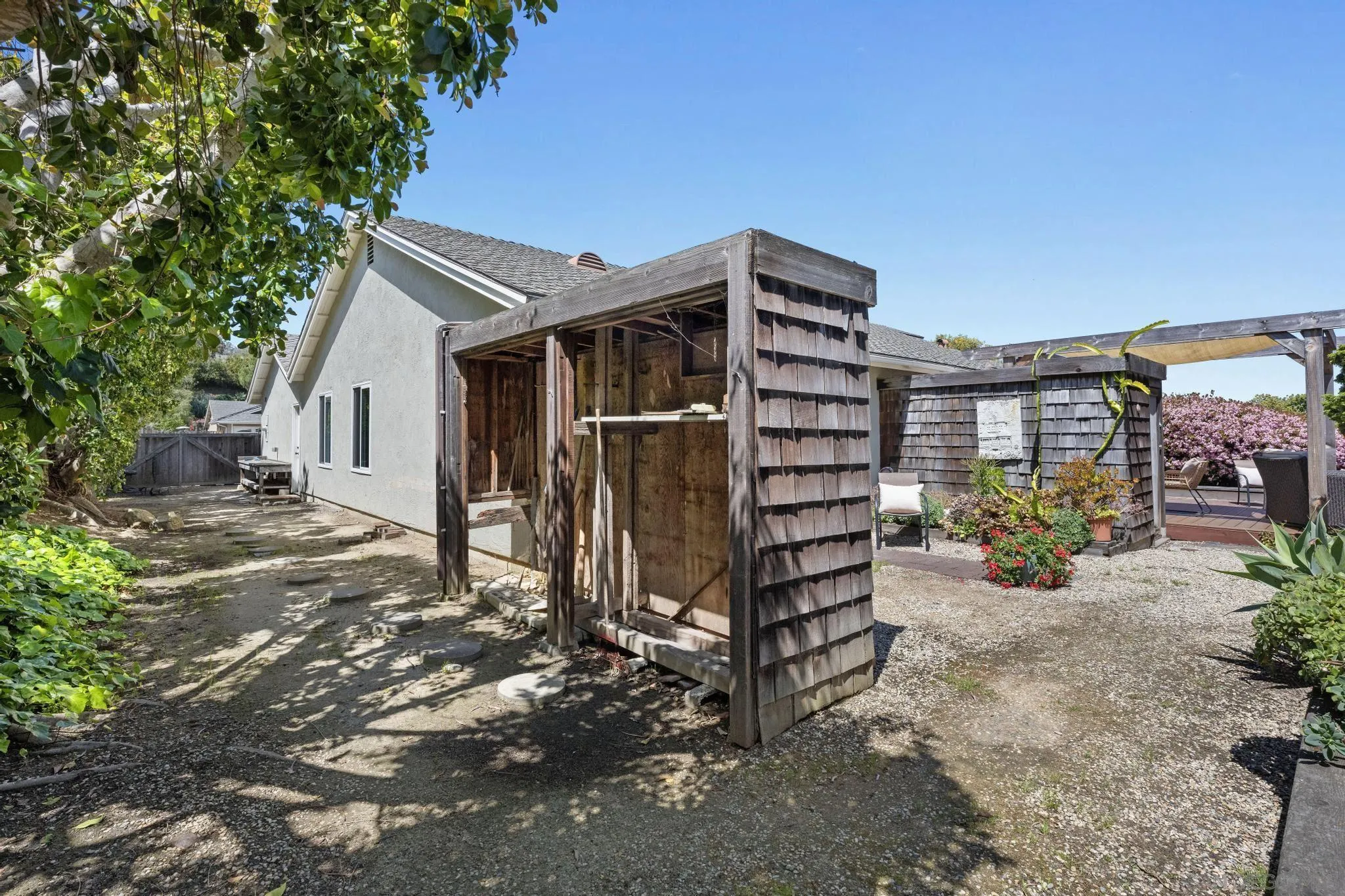 149 Beechtree Drive Encinitas, CA 92024 - Photo 40 of 55 a view of a wooden house with a large window and potted plants