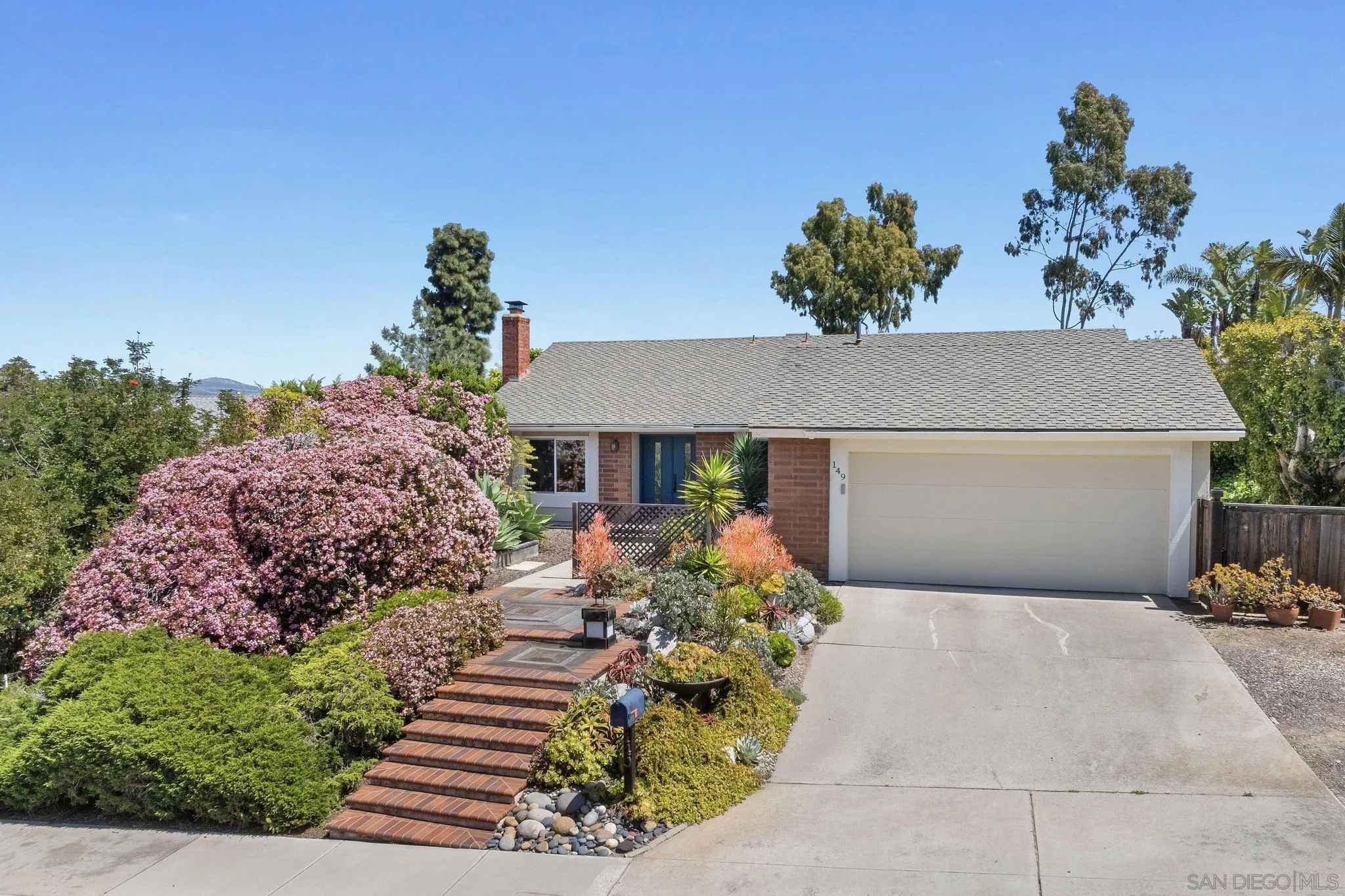 149 Beechtree Drive Encinitas, CA 92024 - Photo 41 of 55 a front view of a house with a yard and a outdoor seating