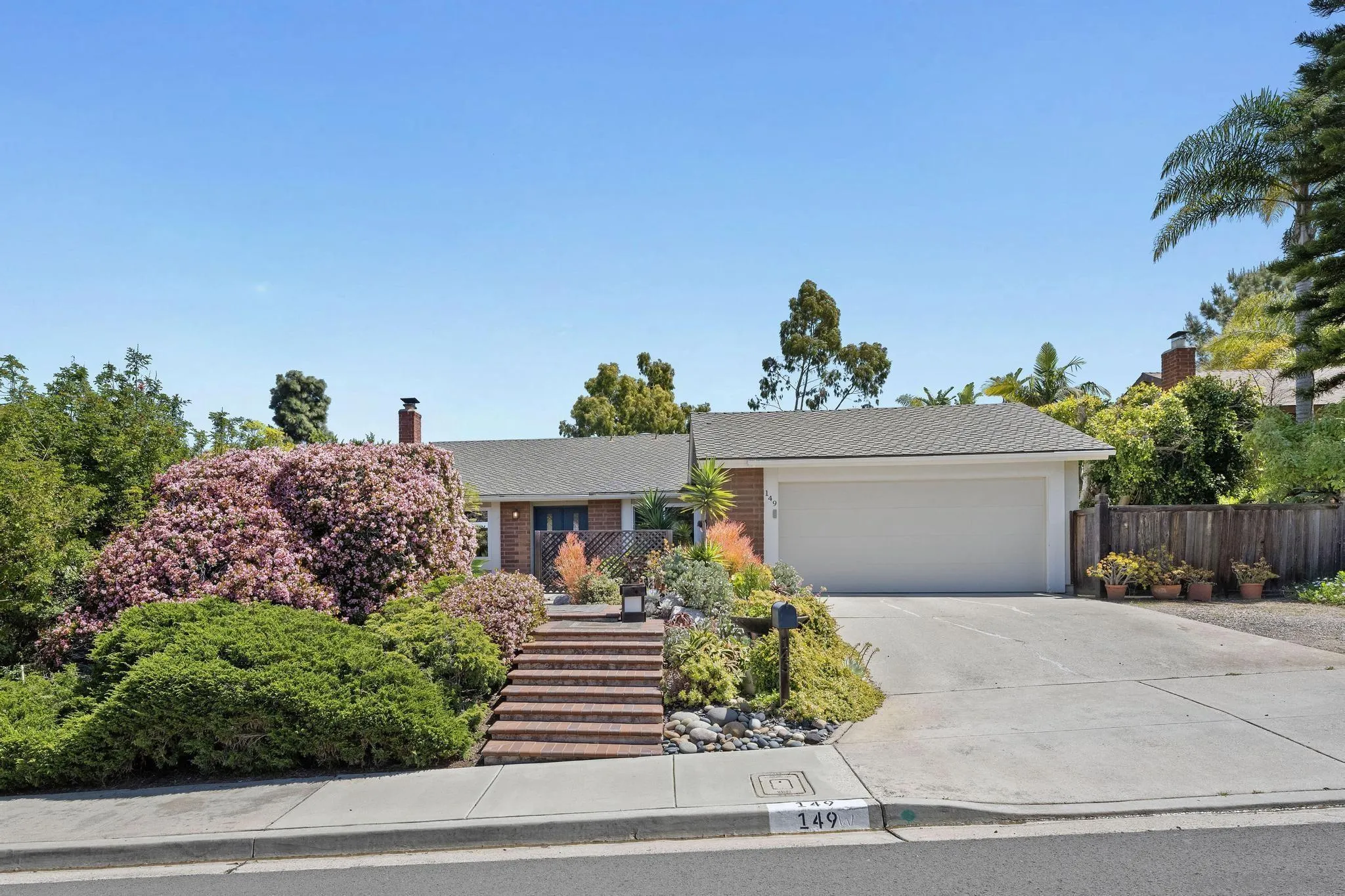 149 Beechtree Drive Encinitas, CA 92024 - Photo 55 of 55 a front view of a house with a yard and potted plants