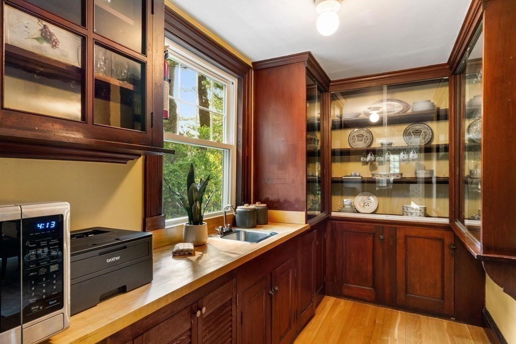 24 Percy Road Lexington, MA 02421 - Photo 13 of 38 a kitchen with stainless steel appliances granite countertop a sink and wooden cabinets
