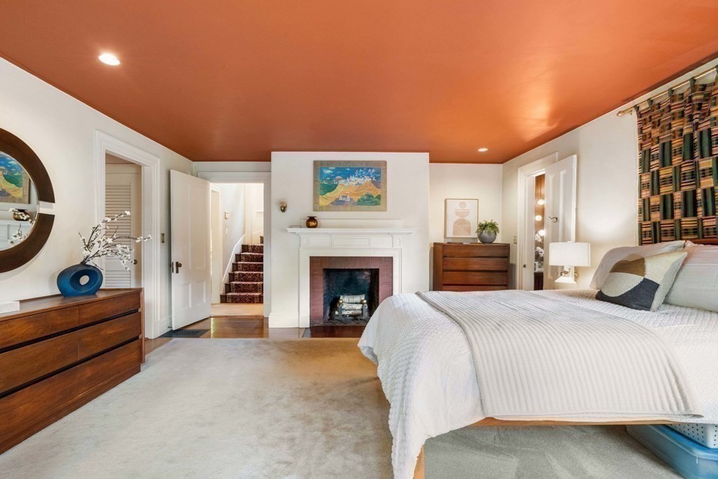 24 Percy Road Lexington, MA 02421 - Photo 18 of 38 a bed room with a bed and a fireplace