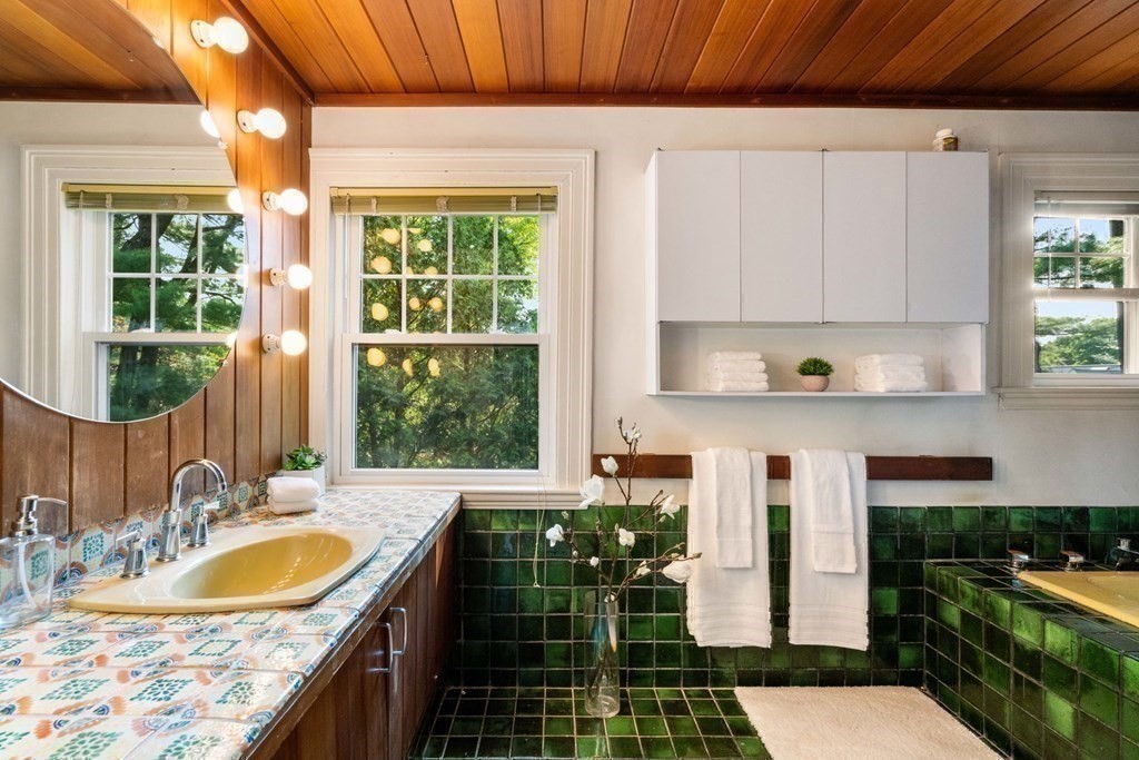 24 Percy Road Lexington, MA 02421 - Photo 20 of 38 a bathroom with a granite countertop sink and a large window