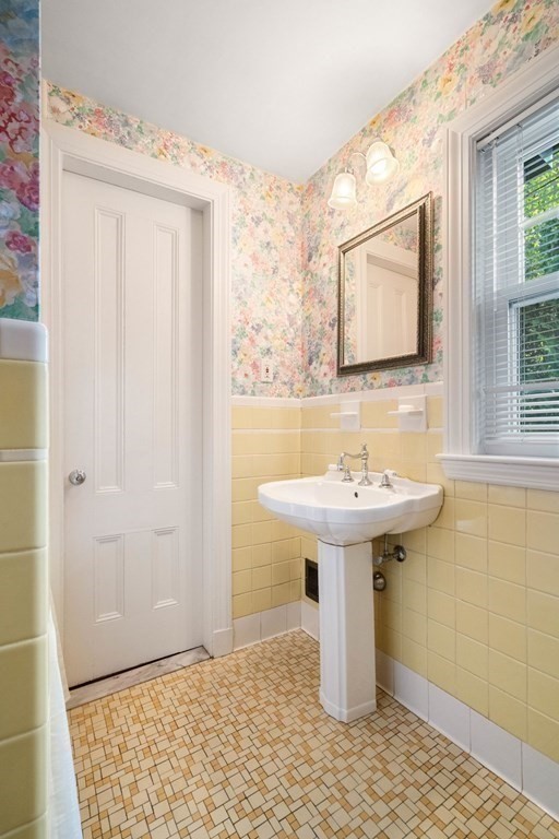 24 Percy Road Lexington, MA 02421 - Photo 24 of 38 a bathroom with a sink a mirror and shower