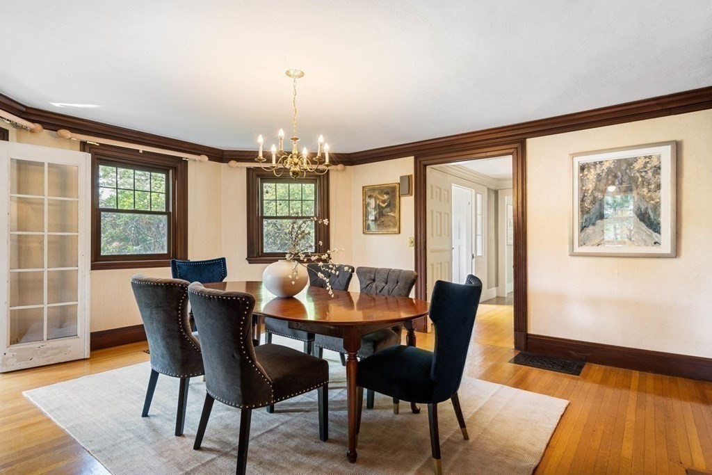 24 Percy Road Lexington, MA 02421 - Photo 10 of 38 a dining room with furniture a chandelier and wooden floor