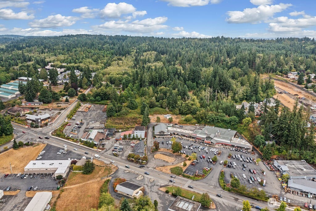 26516 Lindvog Road Northeast Kingston, WA 98346 - Photo 11 of 19 an aerial view of a city with lots of residential buildings ocean and mountain view in back