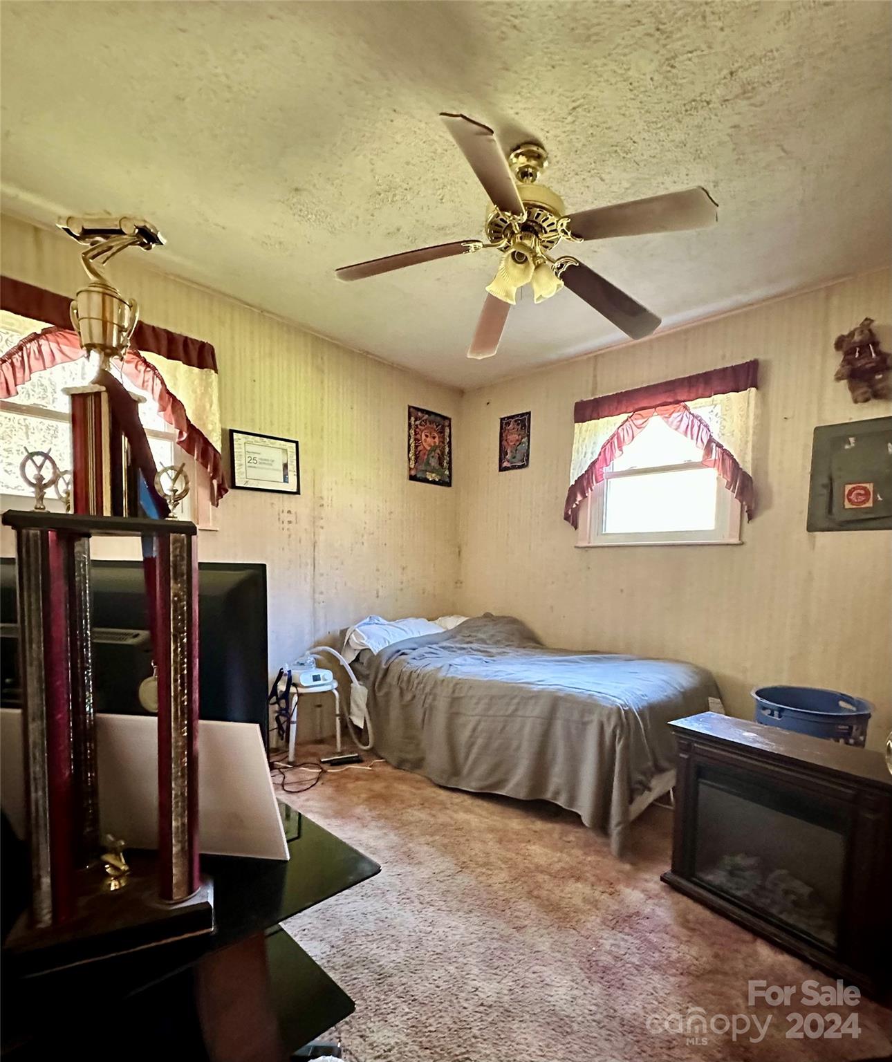 186 Stiles Road Waynesville, NC 28786 - Photo 12 of 18 a bedroom with a bed and a chandelier