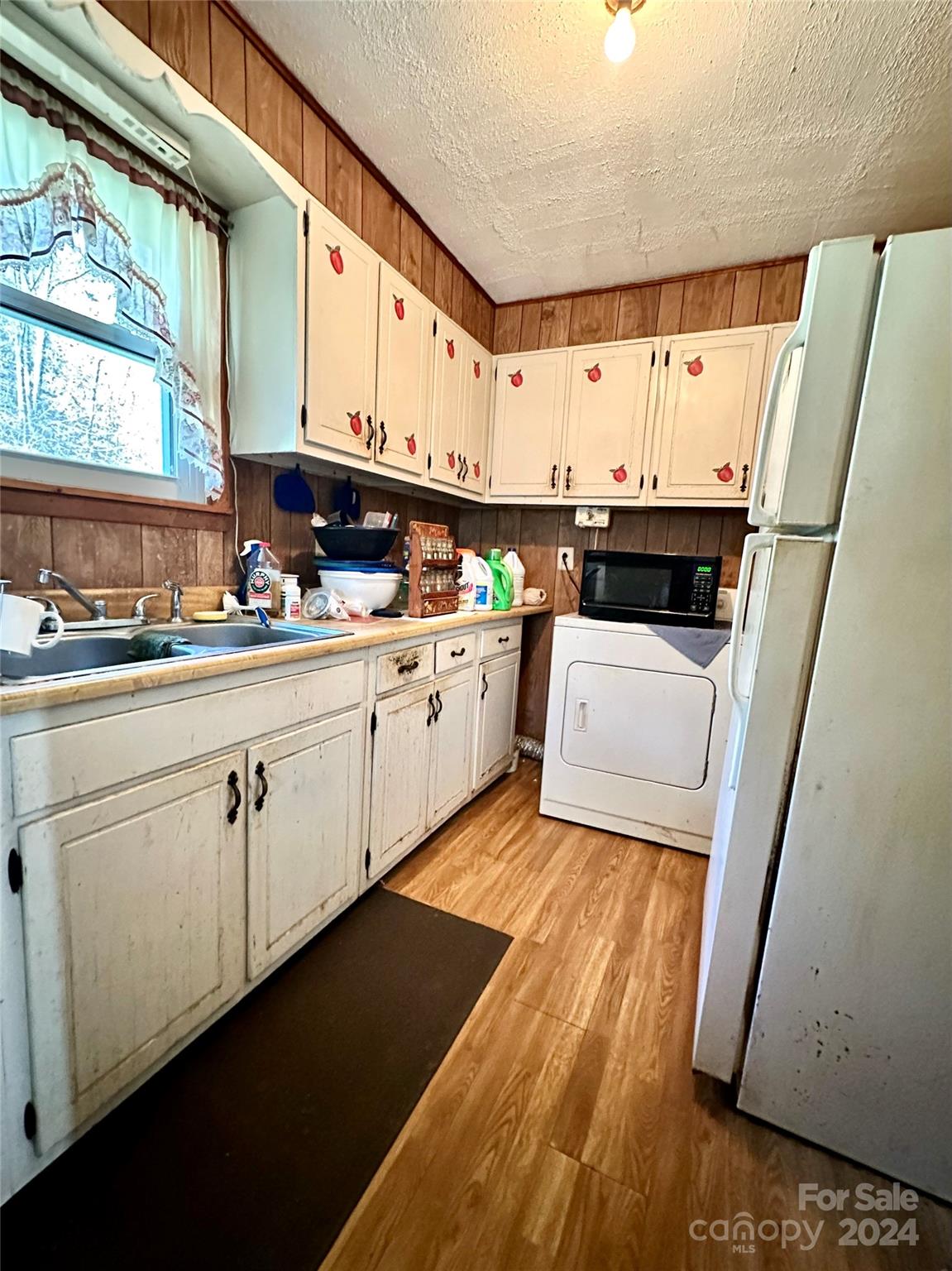 186 Stiles Road Waynesville, NC 28786 - Photo 7 of 18 a kitchen with a sink a stove and cabinets