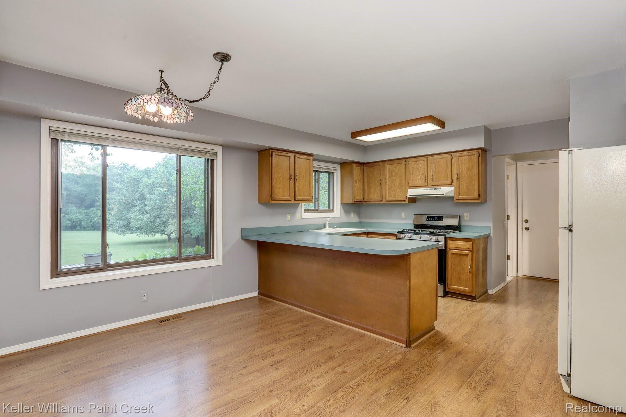 8179 Oakhill Road Clarkston, MI 48348 - Photo 5 of 38 Spacious kitchen with original hardwood floors.