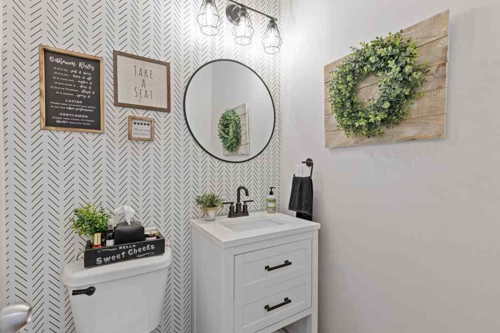 60 Huntley Trace Hoschton, GA 30548 - Photo 16 of 50 a bathroom with a sink a mirror and a toilet