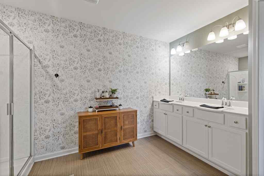 60 Huntley Trace Hoschton, GA 30548 - Photo 28 of 50 a kitchen with stainless steel appliances a stove and white cabinets