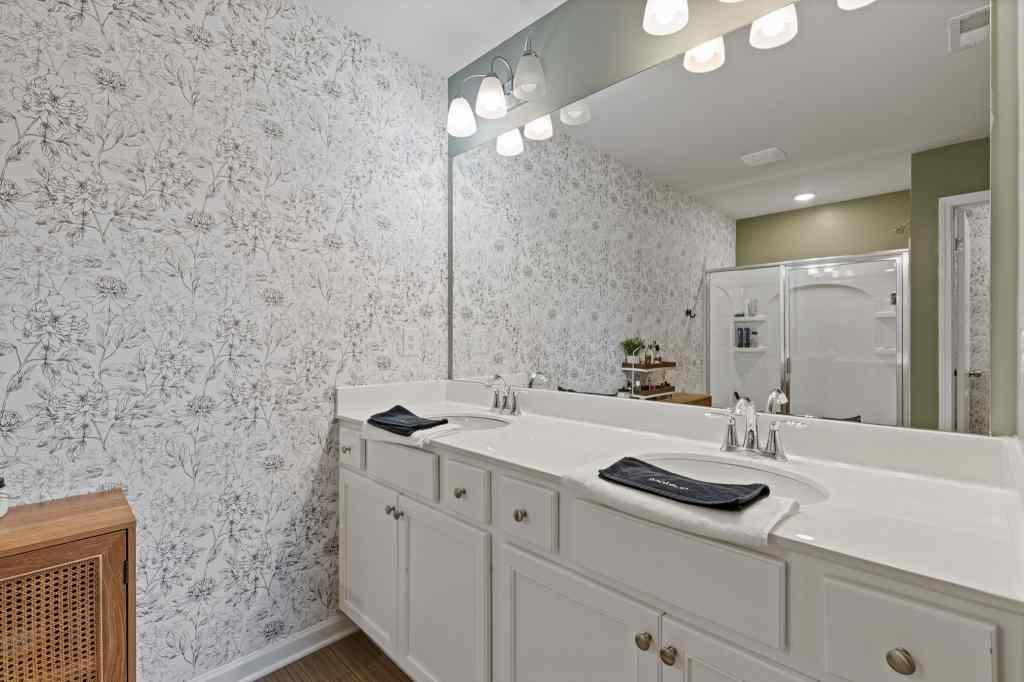 60 Huntley Trace Hoschton, GA 30548 - Photo 29 of 50 a bathroom with a sink and a mirror