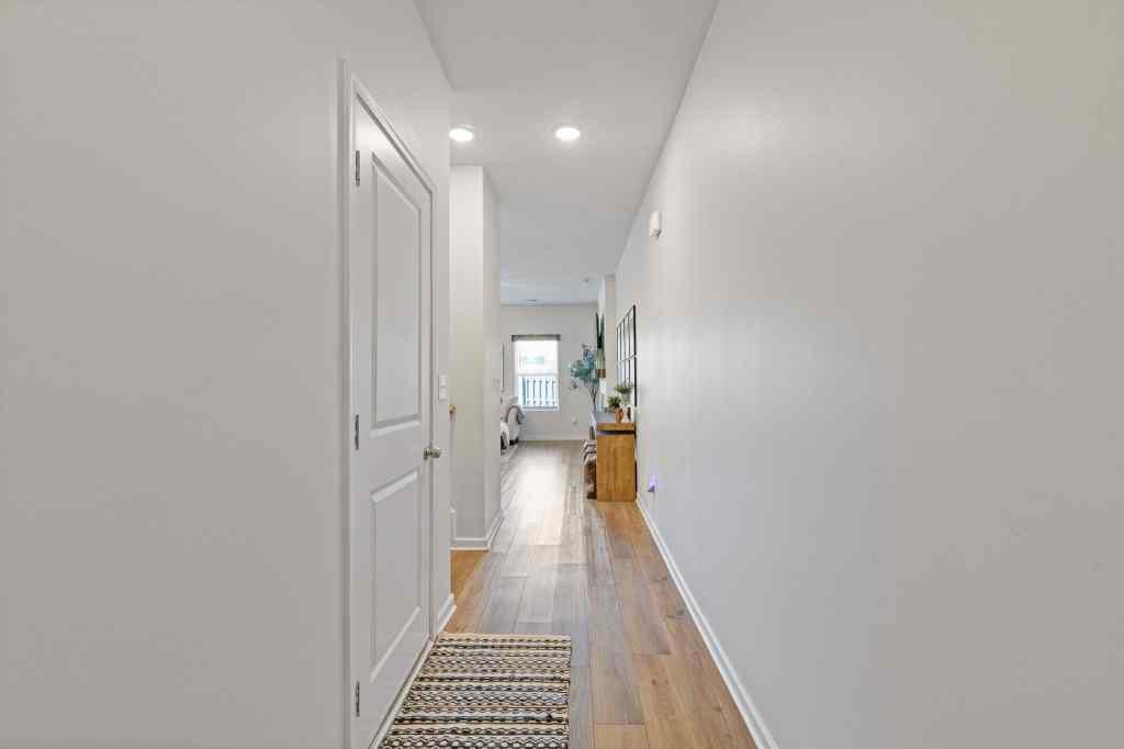 60 Huntley Trace Hoschton, GA 30548 - Photo 3 of 50 a view of a hallway with wooden floor and staircase