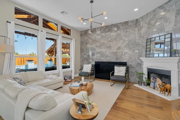 a living room with furniture fireplace and window