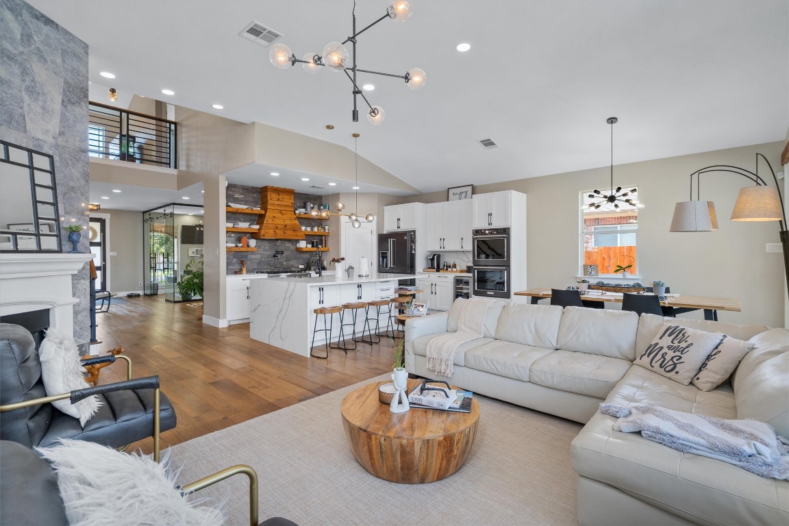 542 Centerbrook Place Round Rock, TX 78665 - Photo 13 of 40 a living room with furniture a fireplace and a chandelier