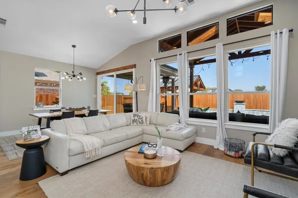 a living room with furniture and a chandelier