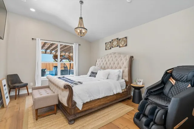 a bedroom with a bed and wooden floor