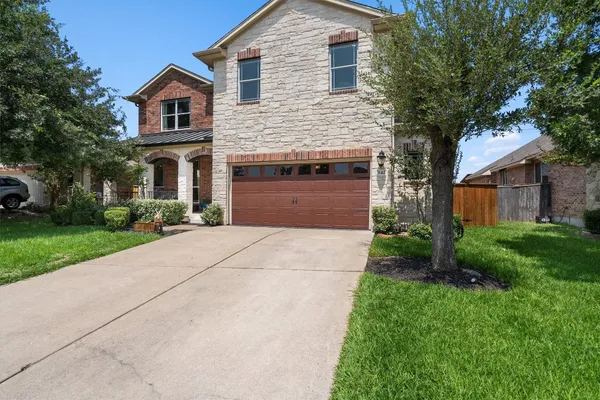 a front view of house with yard and green space