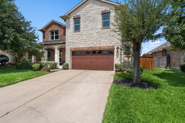a front view of house with yard and green space