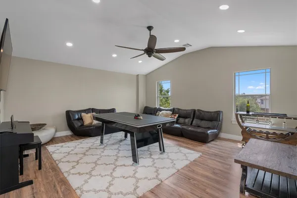 a living room with furniture a rug and a chandelier