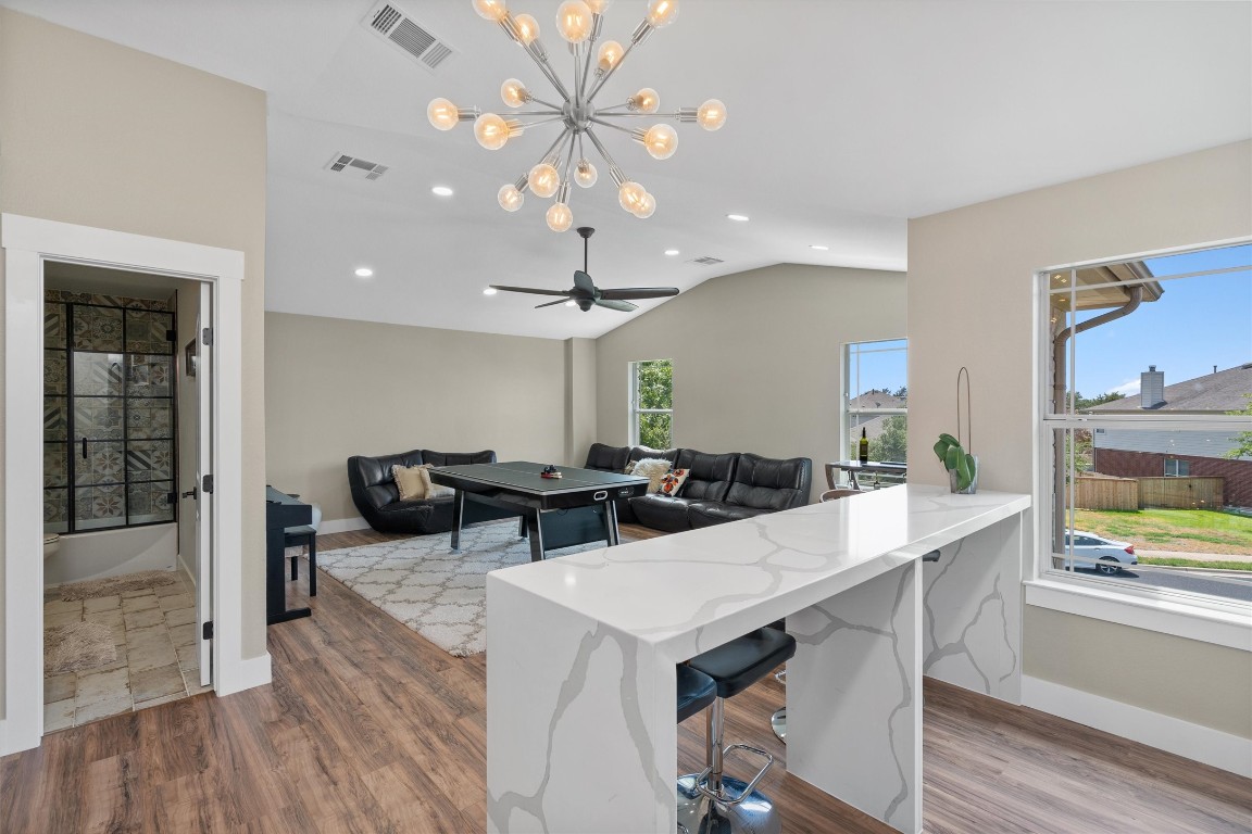 542 Centerbrook Place Round Rock, TX 78665 - Photo 26 of 40 a view of a dining room with furniture a chandelier and wooden floor