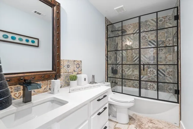 a bathroom with a sink toilet and shower