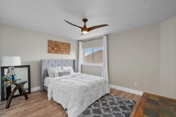 a bedroom with a large bed and a window