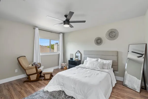 a bedroom with a bed and chair