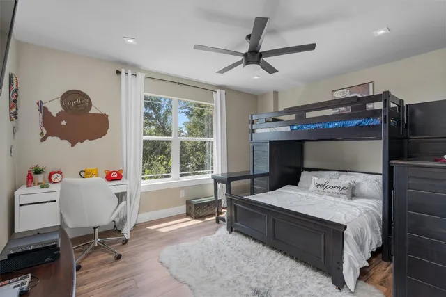 a bedroom that has a bed and a table in it