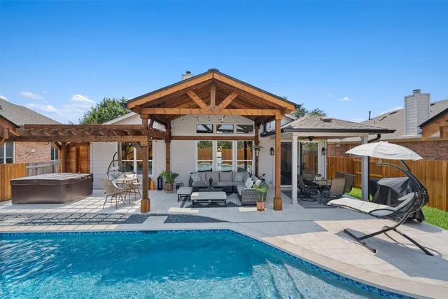 a patio with a table and chairs under an umbrella