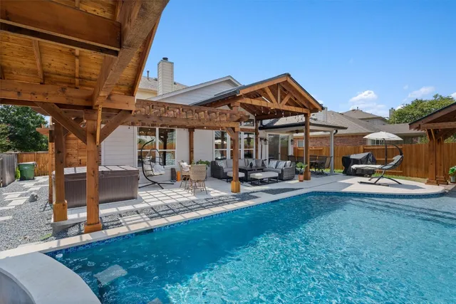 a view of a house with backyard porch and sitting area
