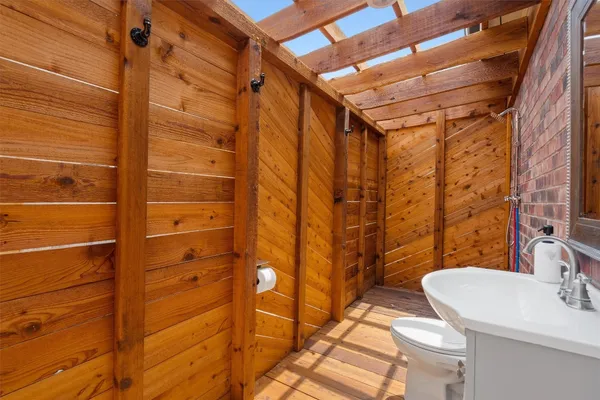 a bathroom with a sink toilet and shower