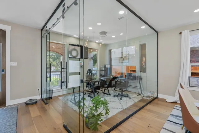 a very nice looking living room with a large window and chairs