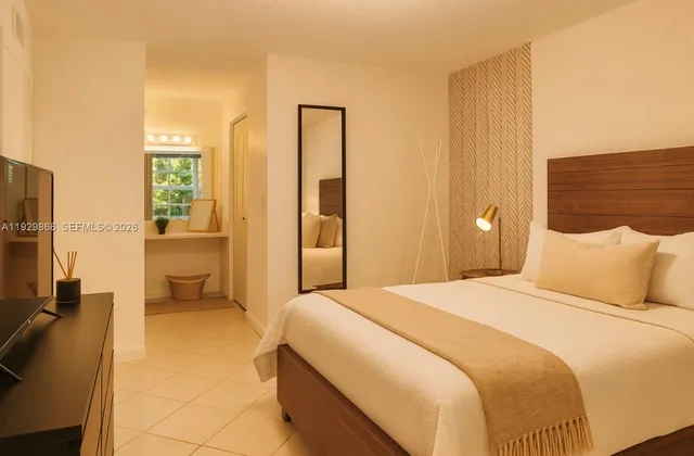 a bedroom with a bed and a large mirror