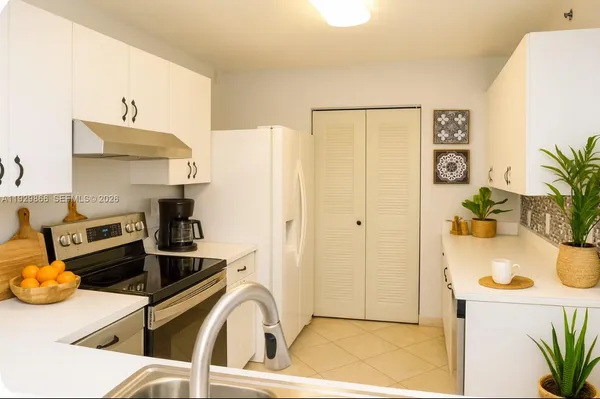a kitchen with stainless steel appliances granite countertop a sink and cabinets