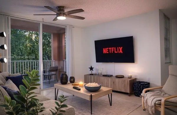 a living room with furniture a rug and a flat screen tv