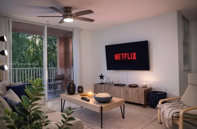 a living room with furniture a rug and a flat screen tv
