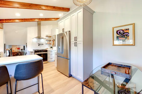 a kitchen with stainless steel appliances a refrigerator and a stove top oven
